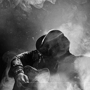 Ryano playing guitar in smoke