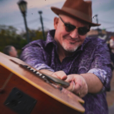 Uncle Ryano looking down the barrel of his guitar